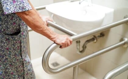 elderly woman using sink grab rails