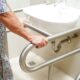 elderly woman using sink grab rails