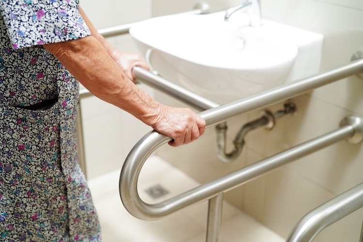 elderly woman using sink grab rails