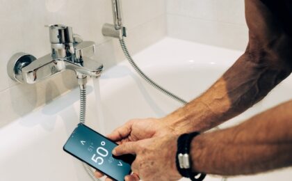 man controlling heating using phone