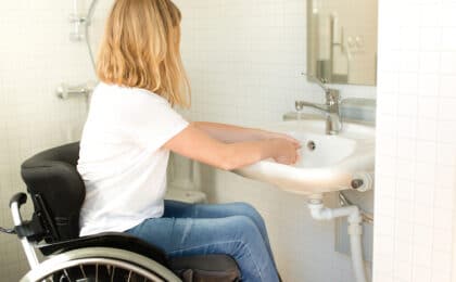 person wheelchair washing hands