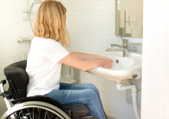 person wheelchair washing hands