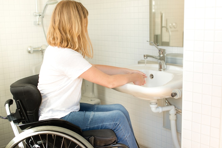 person wheelchair washing hands