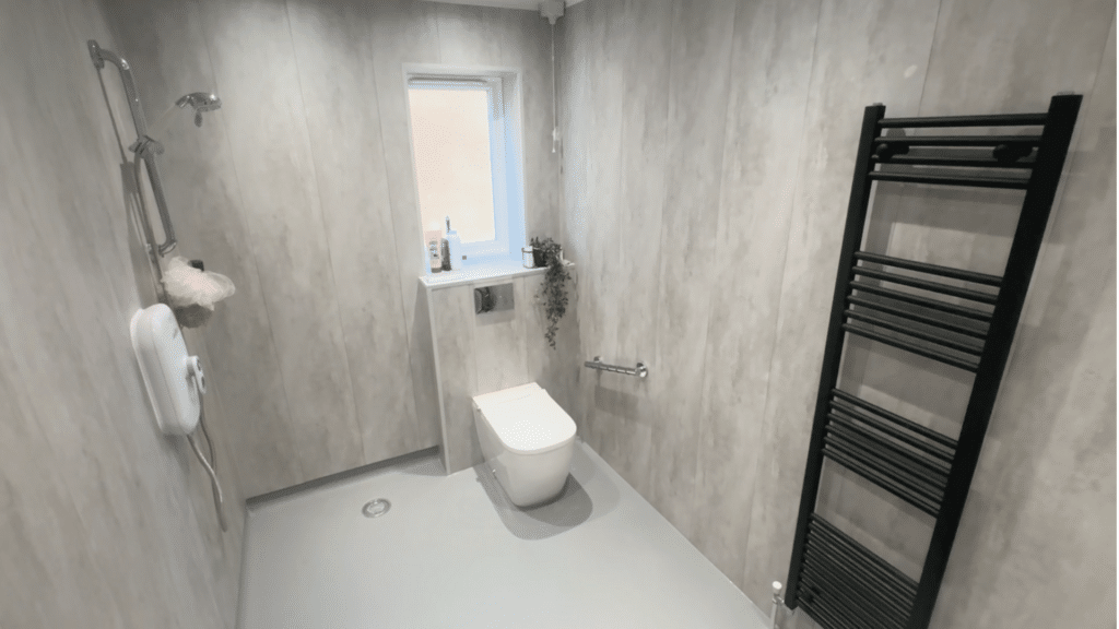 Modern walk-in shower with grab, designed for elderly use.