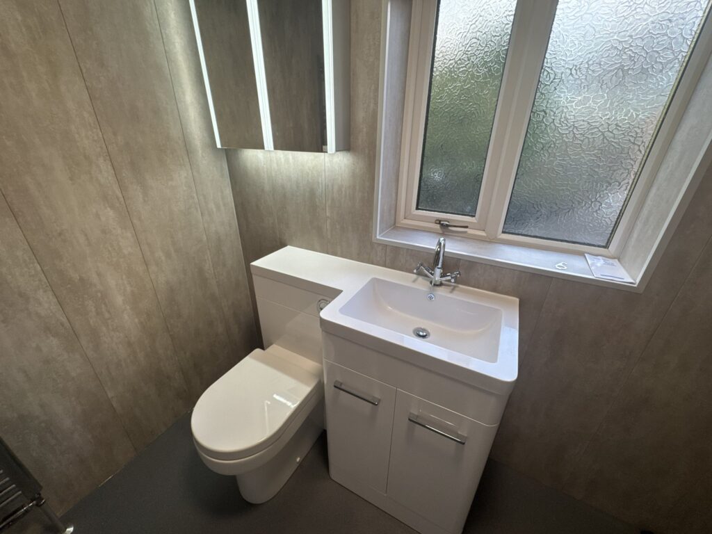 Brian's new vanity unit with integrated basin, concealed-cistern toilet and LED mirror cabinet