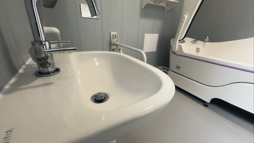 The new basin and lever tap in Room 3, with the assisted care bath alongside