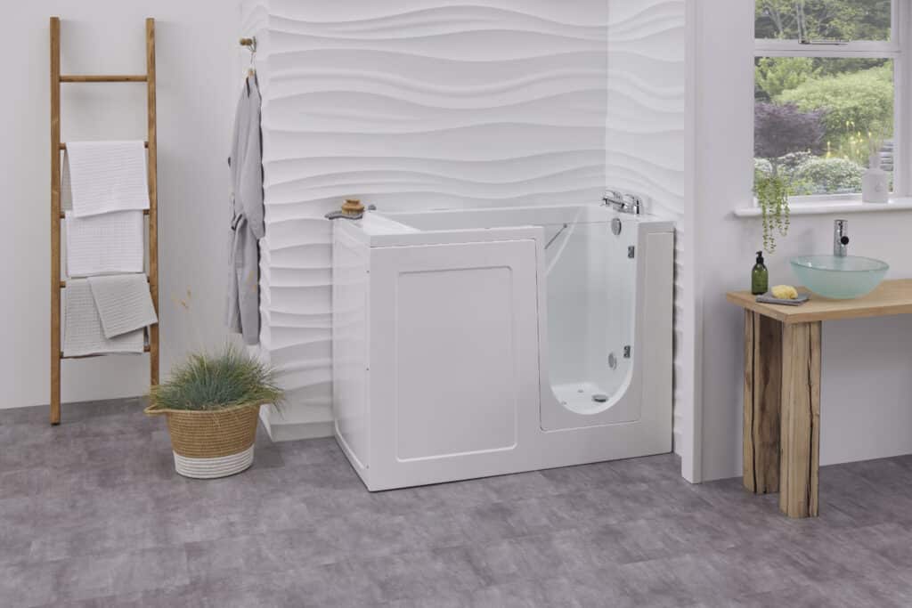 Walk-in bath with clear glass door and built-in seat in a modern bathroom