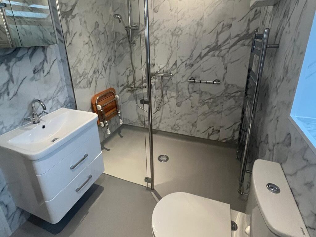 Lesley's wet room, with the vanity basin, mirror cabinet, walk-in shower and folding seat.