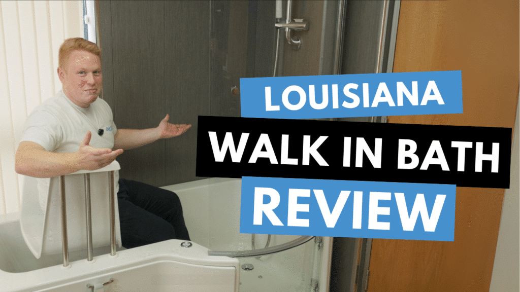 Sam from Age Care Bathrooms sits inside a white Louisiana Walk-In Bath, gesturing towards the camera during a product review.