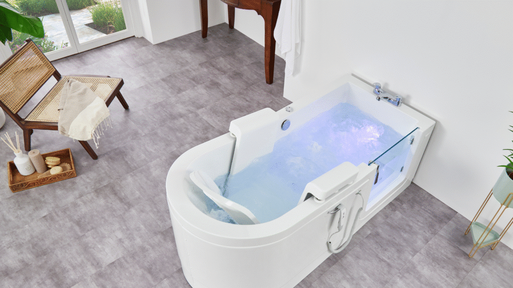 The Easy Riser Walk-in Bath filled with water with the lights turned on. It is in an open, large bathroom.