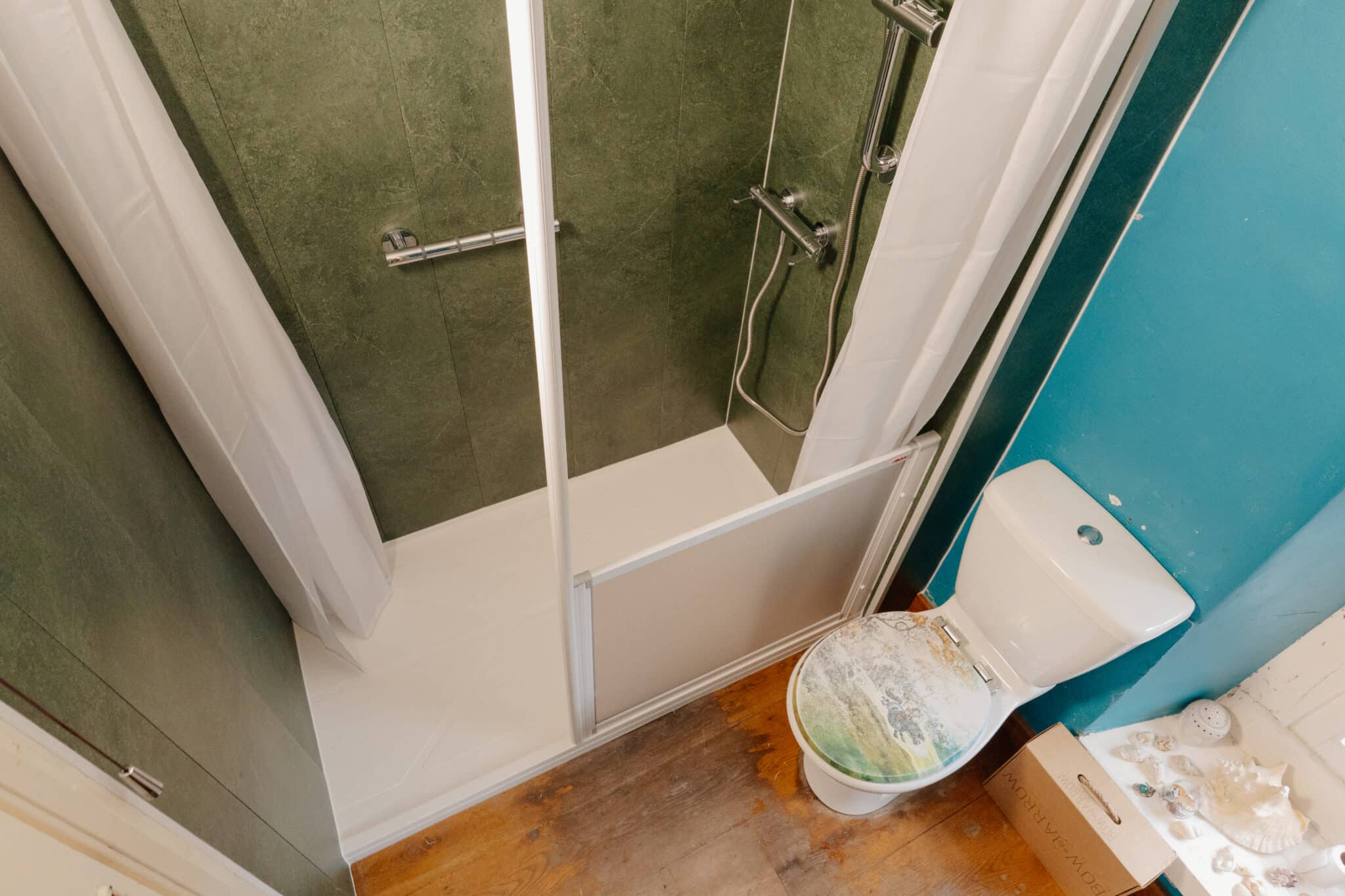 Overhead view of Denise's finished bathroom, with the new walk-in shower beside the toilet.