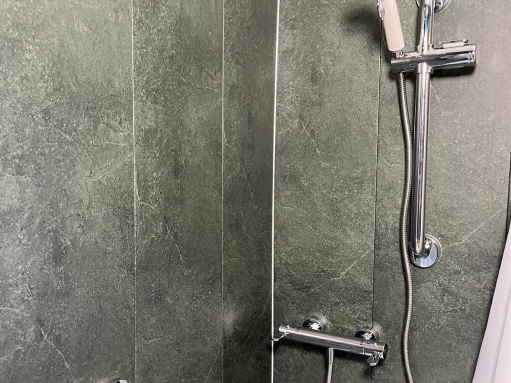 The thermostatic shower controls and handheld head in Denise's new walk-in shower.