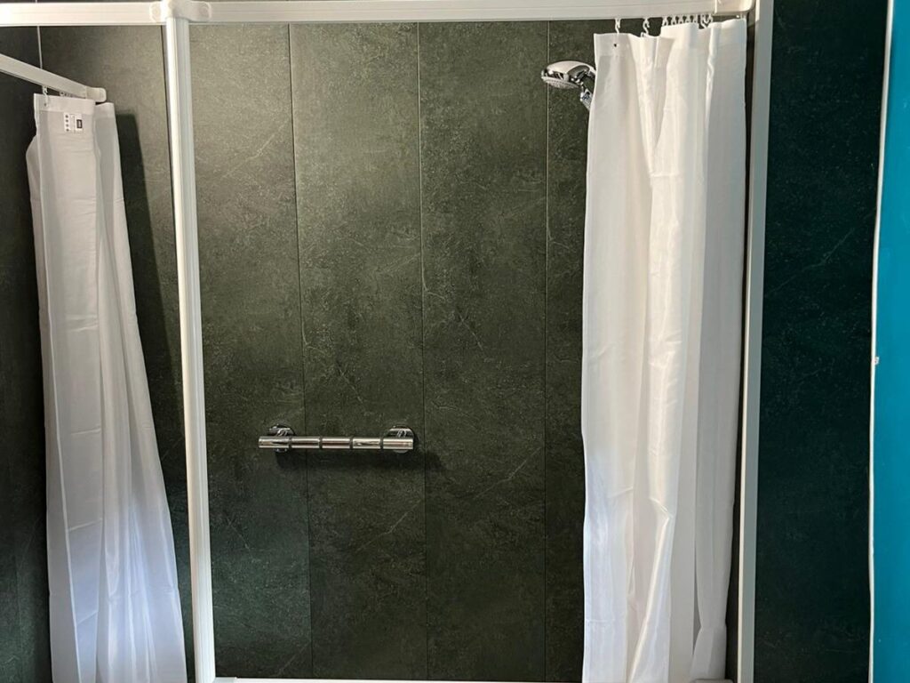 The new easy-access shower with half-height screens and curtains for privacy