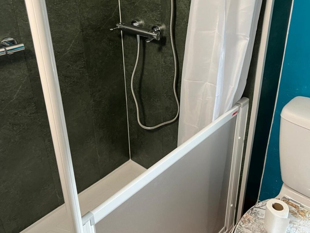 The half-height door on Denise's walk-in shower, low enough for easy assistance.