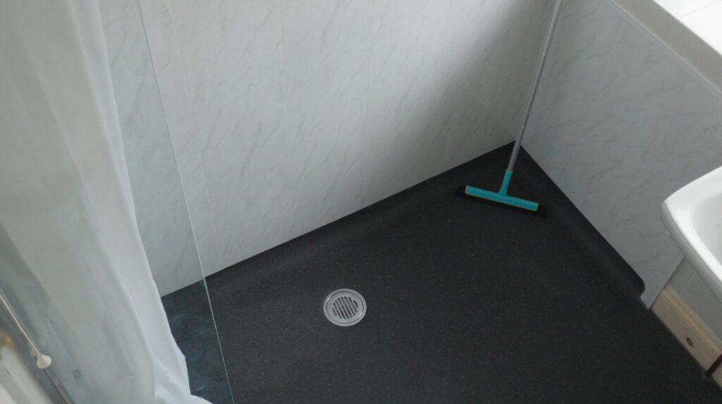 The level, anti-slip wet room floor in Peter's bathroom, with a central drain and no step to the shower.