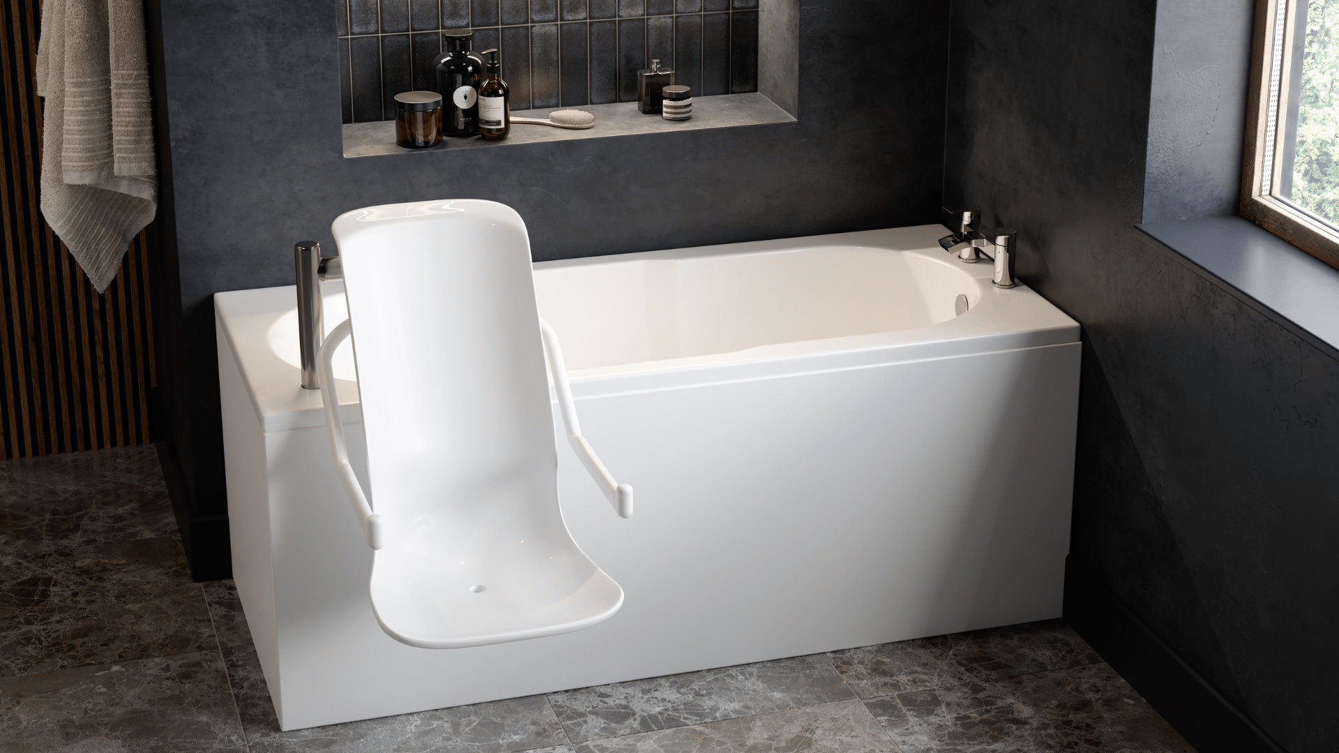 A modern accessible bathroom featuring an Omega walk-in bath with a powered seat lift. The white rectangular bath is equipped with a high-backed, contoured powered seat and integrated armrests that extend over the side for easy entry. The room has dark grey textured walls with a recessed shelf for toiletries and large grey marble-effect floor tiles. A large window on the right provides natural light, and a neutral-toned towel hangs on the left wall.