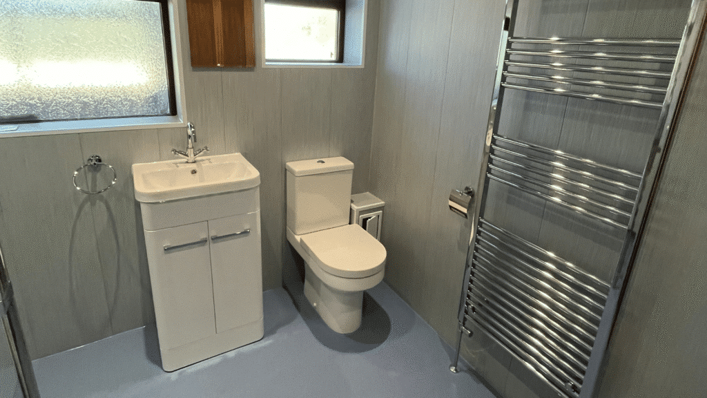 A modern raised-height toilet for the elderly and those with limited mobility, featured in a clean, accessible bathroom setting.