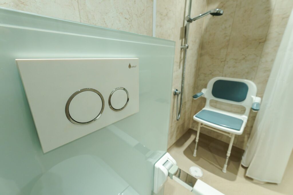 Looking across Olivia's wet room to the level-access shower with its padded fold-down seat.