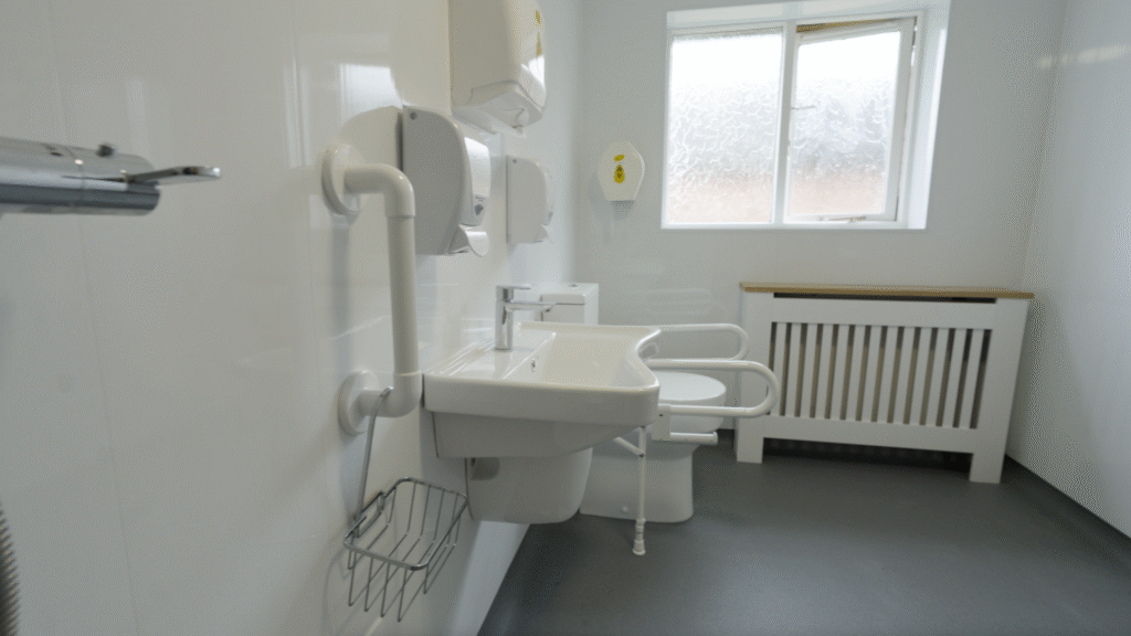 Along the wall of Stella's wet room: thermostatic shower, easy-reach basin and supported toilet.