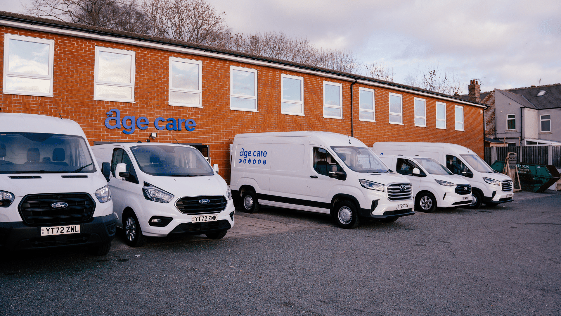 Fleet of Age Care Bathroom vans outside the head office in Chesterfield.