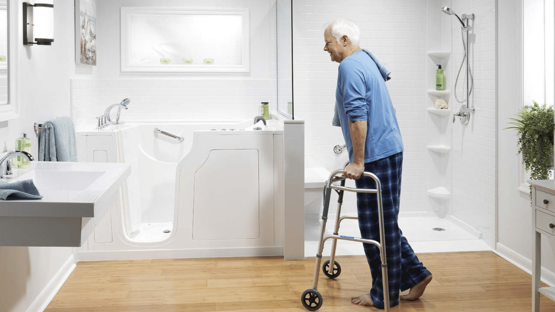 Person with a walker in an accessible bathroom with a walk-in bath and walk-in shower.