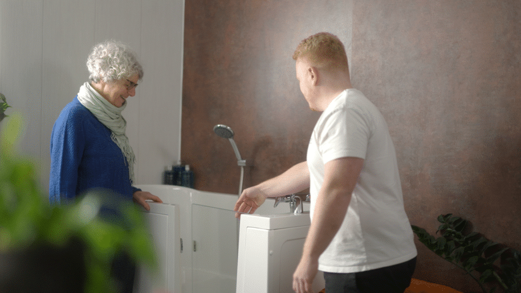 Still image of Sam (Director) talking to a customer during the Age Care Bathrooms TV advert.