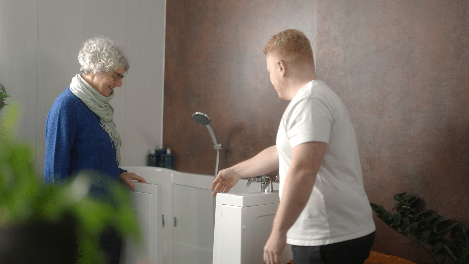 Still image of Sam (Director) talking to a customer during the Age Care Bathrooms TV advert.