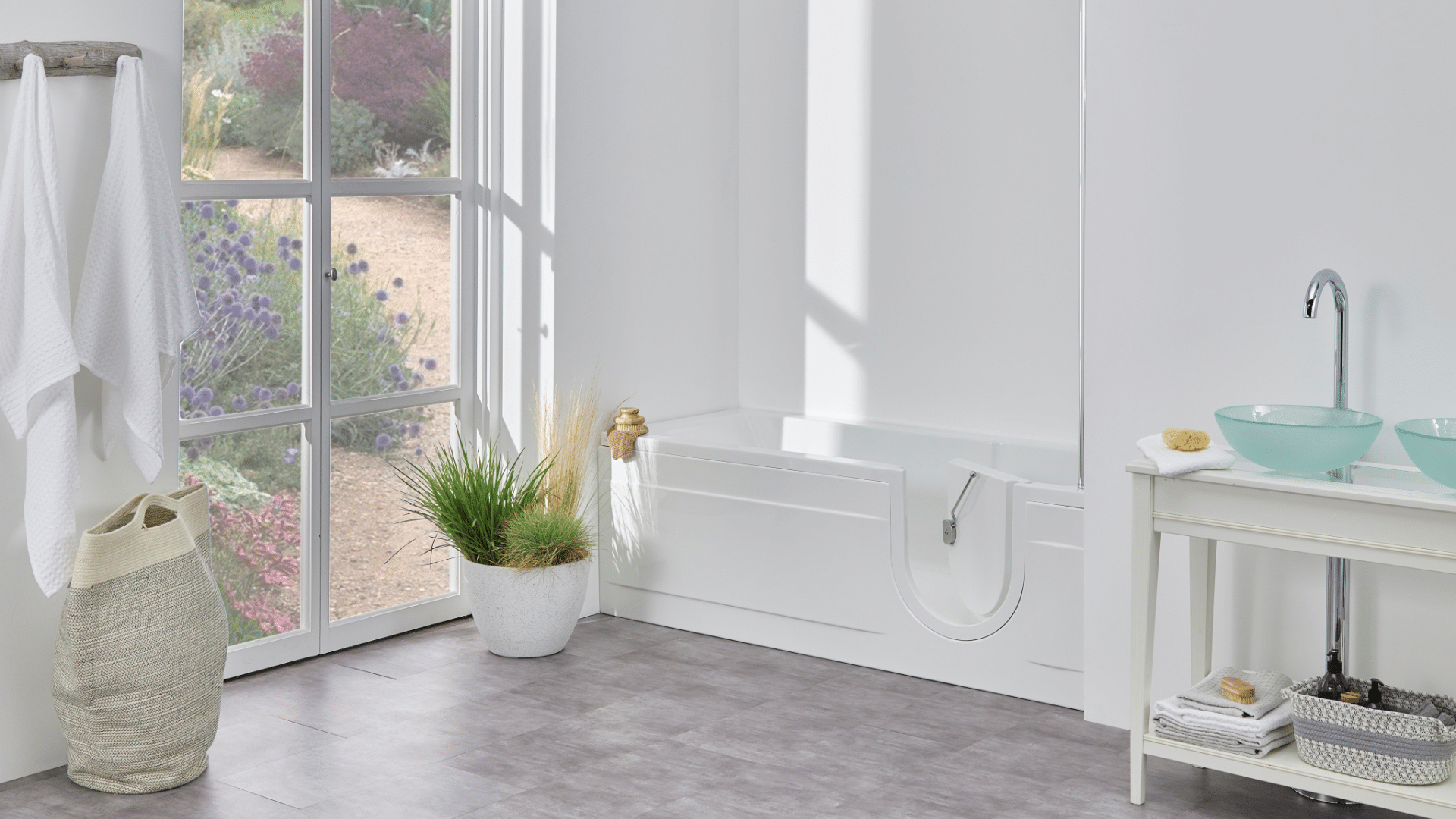 Arizona walk-in bath in a bright, modern bathroom with large windows and garden views.