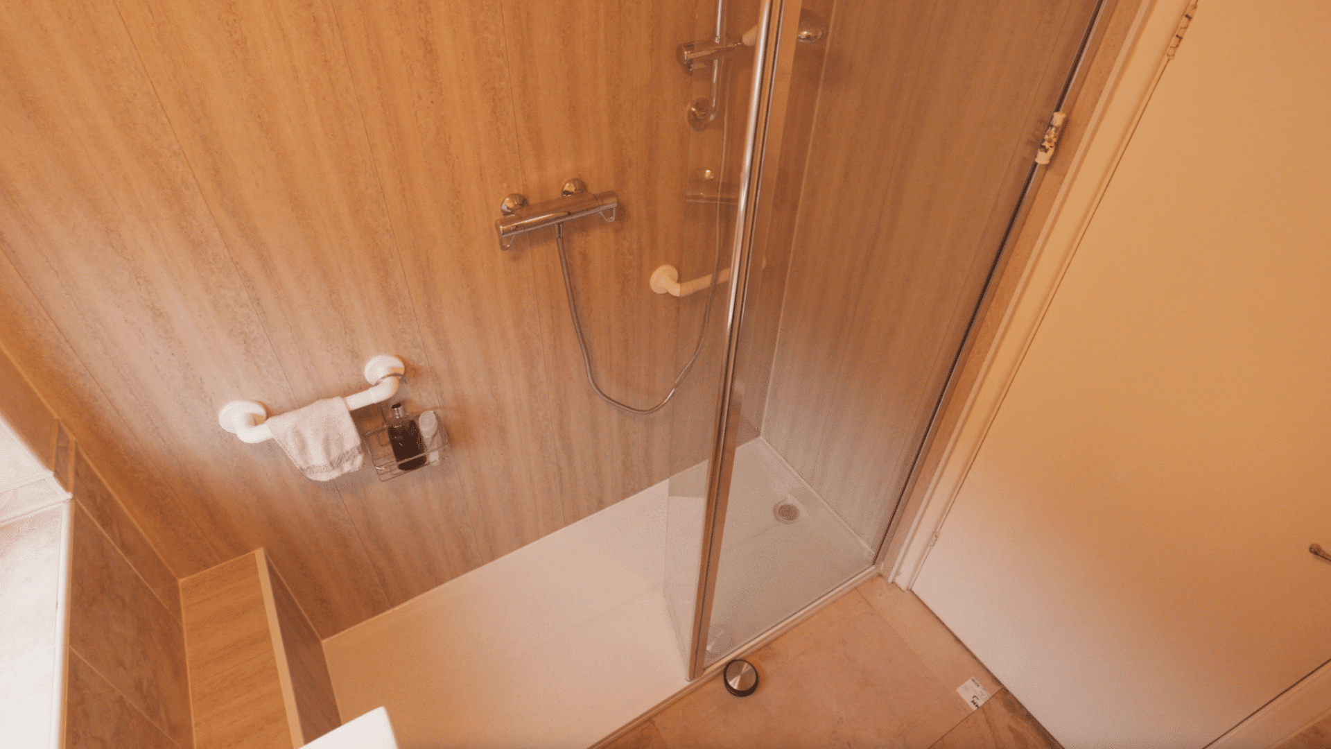 Walk-in shower installation with glass panel installed by Age Care Bathrooms.