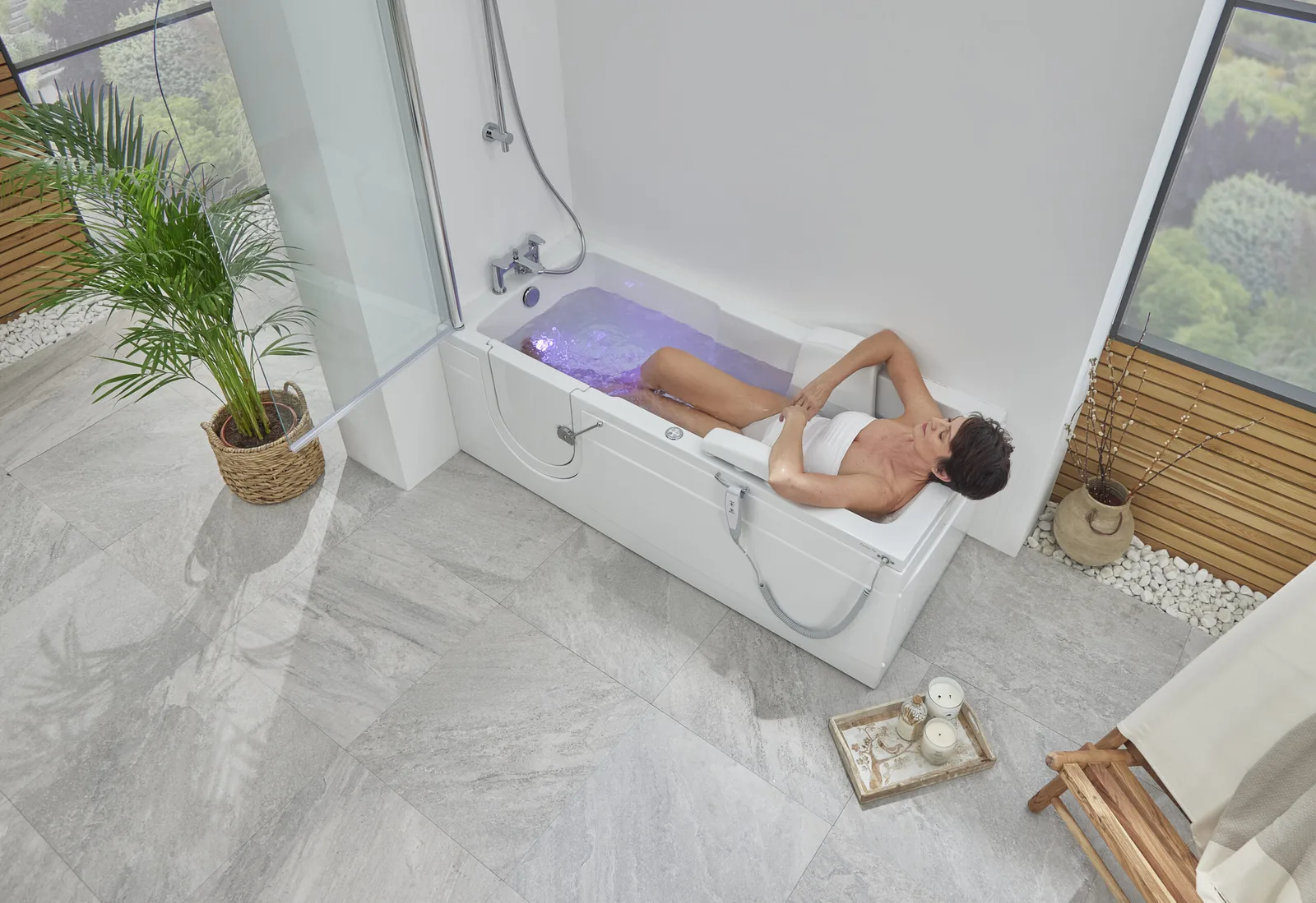 Overhead view of a woman relaxing in the Montana bath with blue spa water running