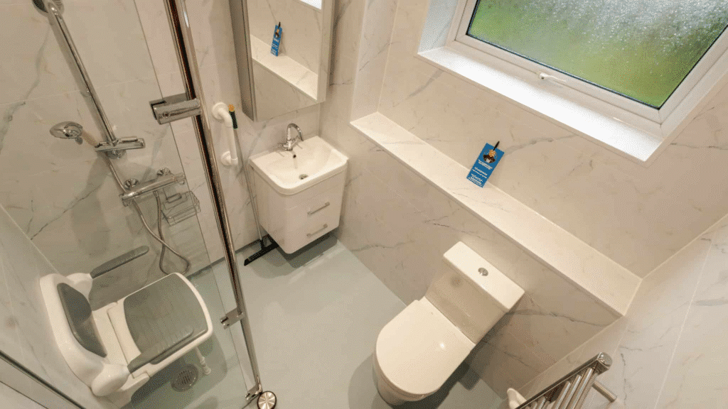 Compact wet room installation by Age Care Bathrooms featuring a shower screen and accessible basin.