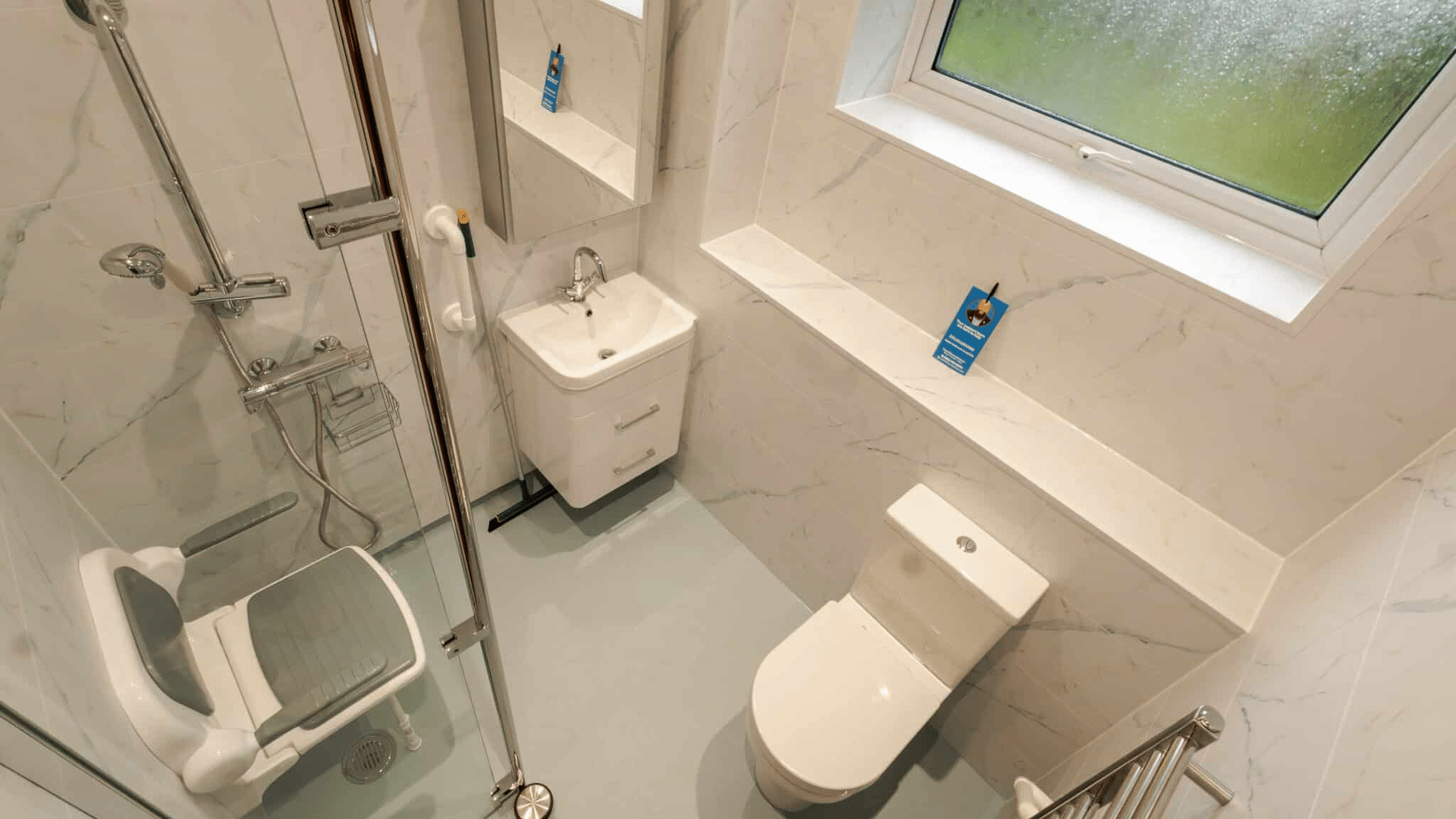 Compact wet room installation by Age Care Bathrooms featuring a shower screen and accessible basin.