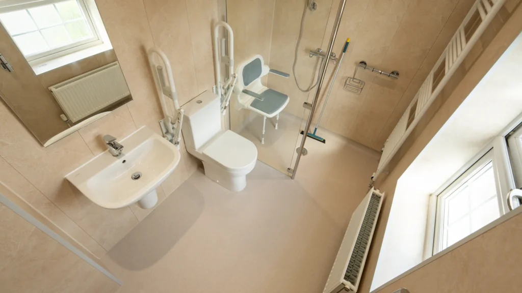 Accessible wet room by Age Care Bathrooms, with a level floor, shower seat and grab rails.