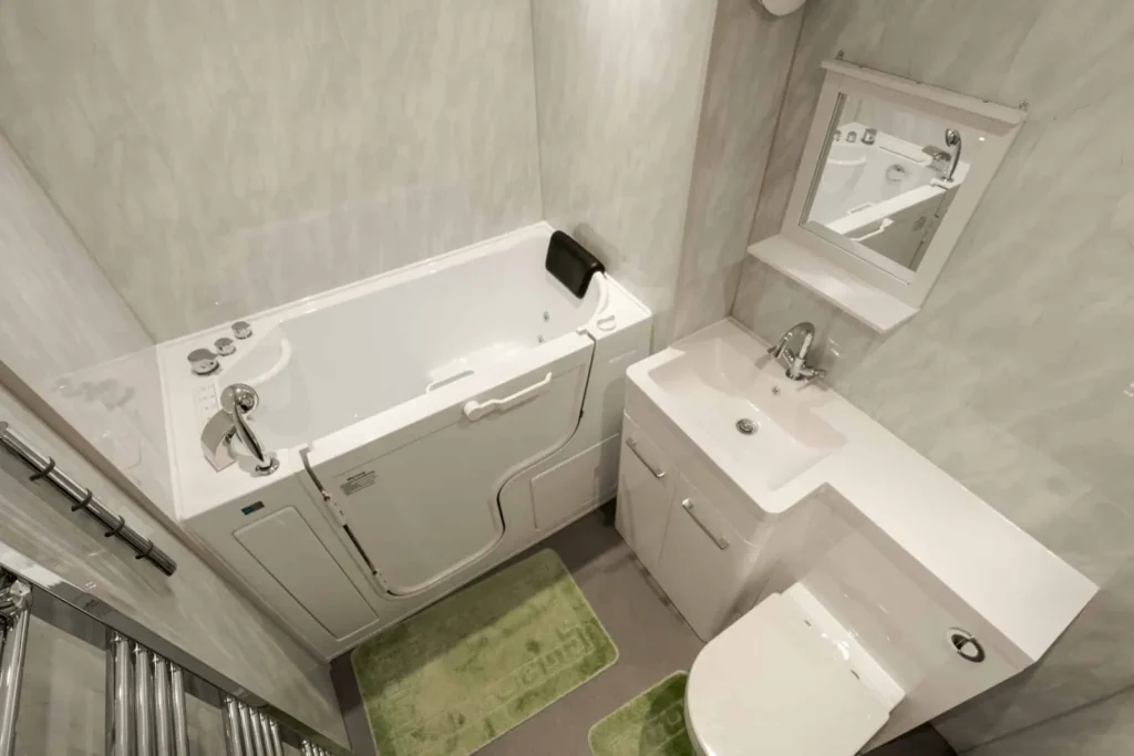 Jerry's walk-in bath installation with a powered seat, toilet and vanity basin