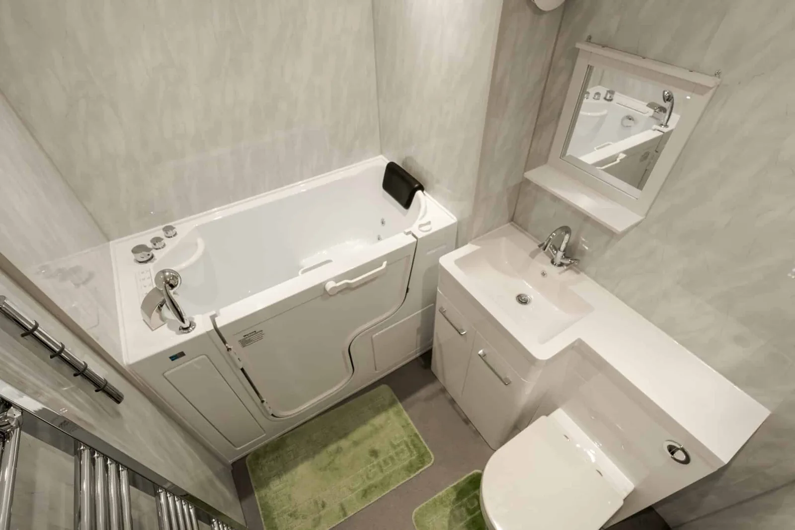 Jerry's walk-in bath installation with a powered seat, toilet and vanity basin