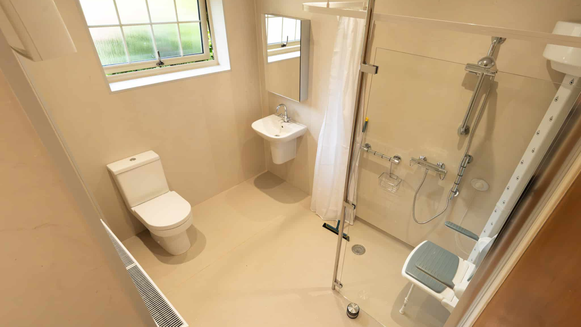 Open plan wet room installation designed and installed by Age Care Bathrooms.