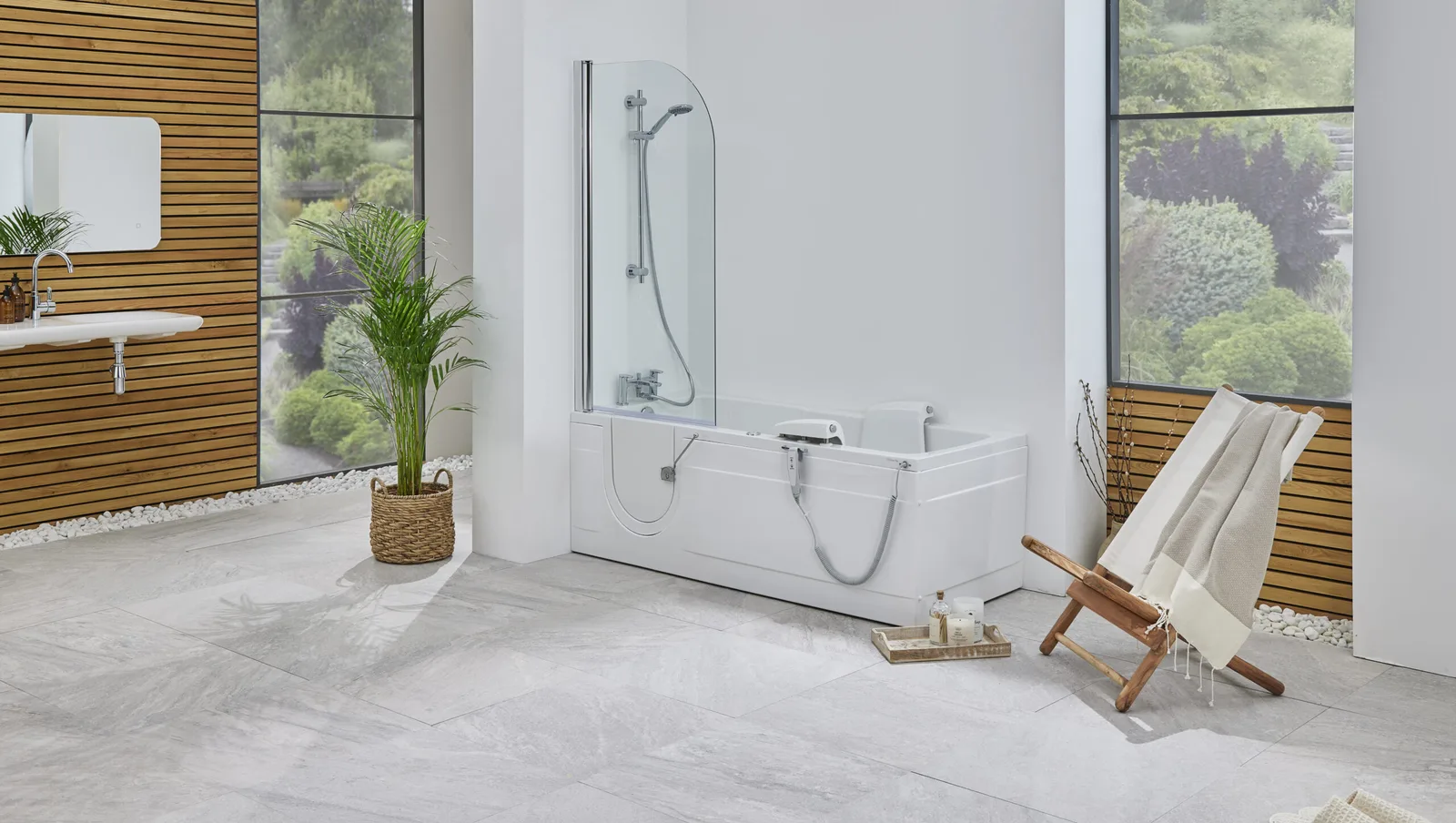 The Montana walk-in bath with shower screen, powered seat and low door in a bright bathroom