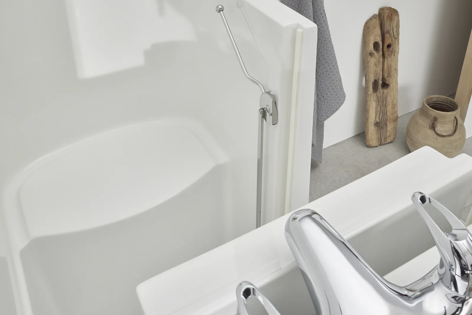 Close-up inside the Oregon walk-in bath showing the deep tub, built-in seat and grab rail