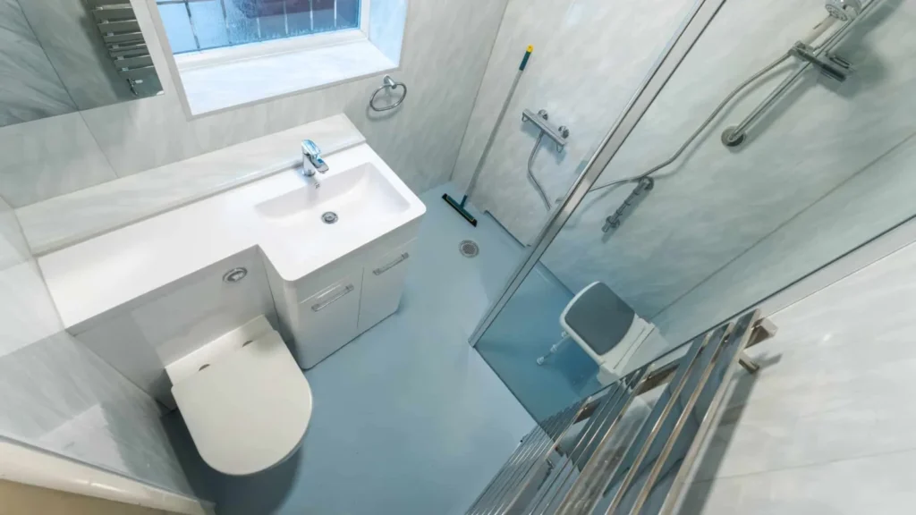 Freya's level-access wet room with a walk-in shower, fold-down seat, vanity basin and toilet