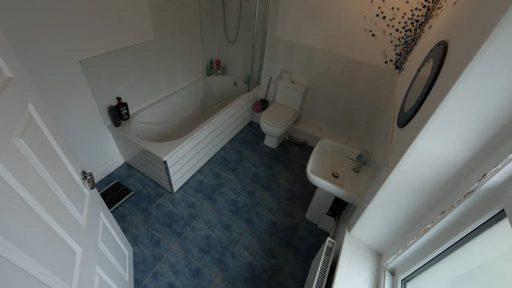Before photo of Peter's bathroom which was tight, dark, and difficult to use every day. Featuring a high side shower bath.