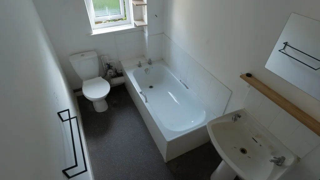 Adrian's old bathroom with a high-sided bath, close-coupled toilet and pedestal basin