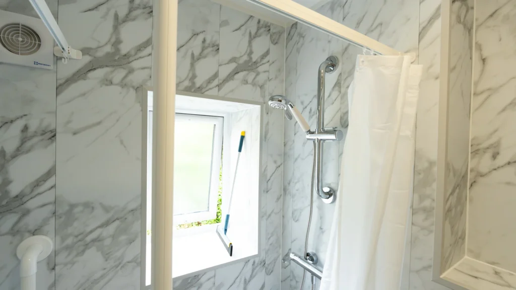 Half-height care screen and thermostatic shower in Adrian's new walk-in shower