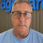 Brian, head of our surveyor team, in front of the Age Care sign at our office.