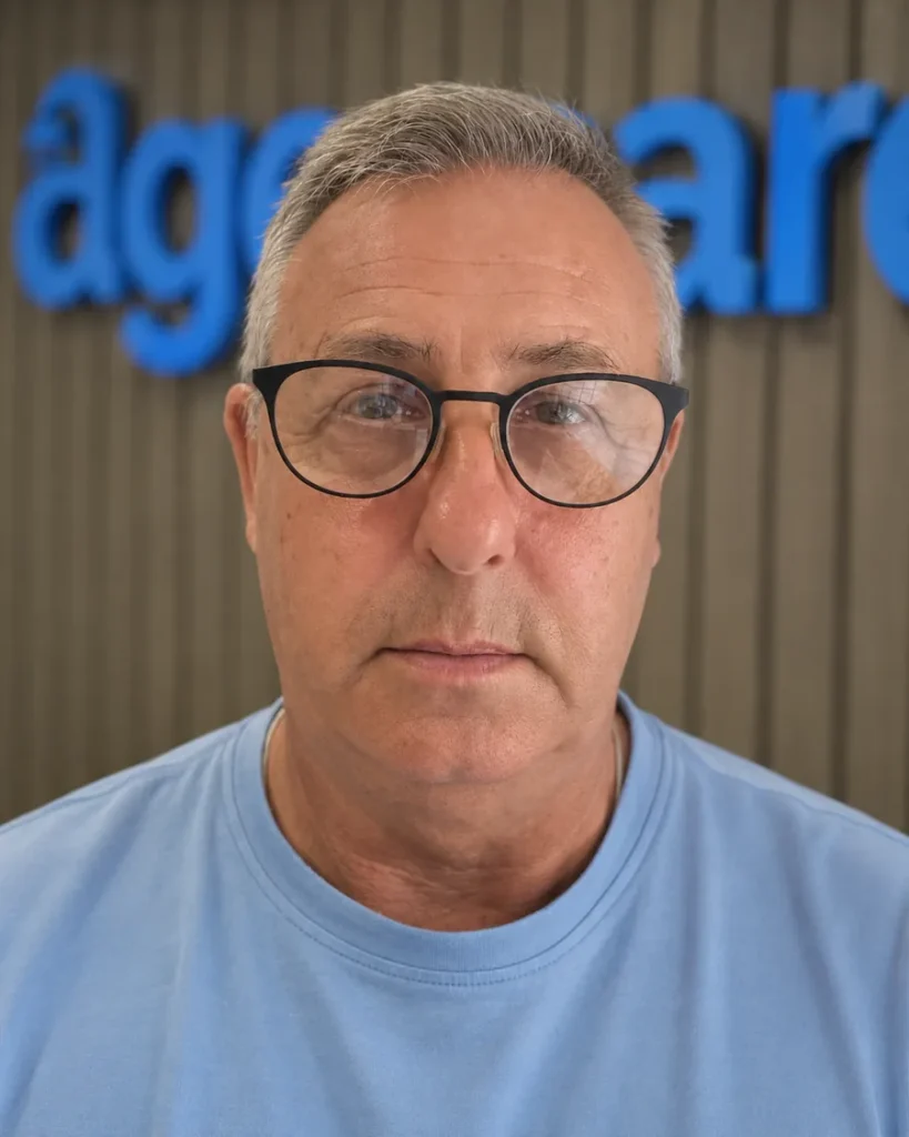 Brian, head of our surveyor team, in front of the Age Care sign at our office.