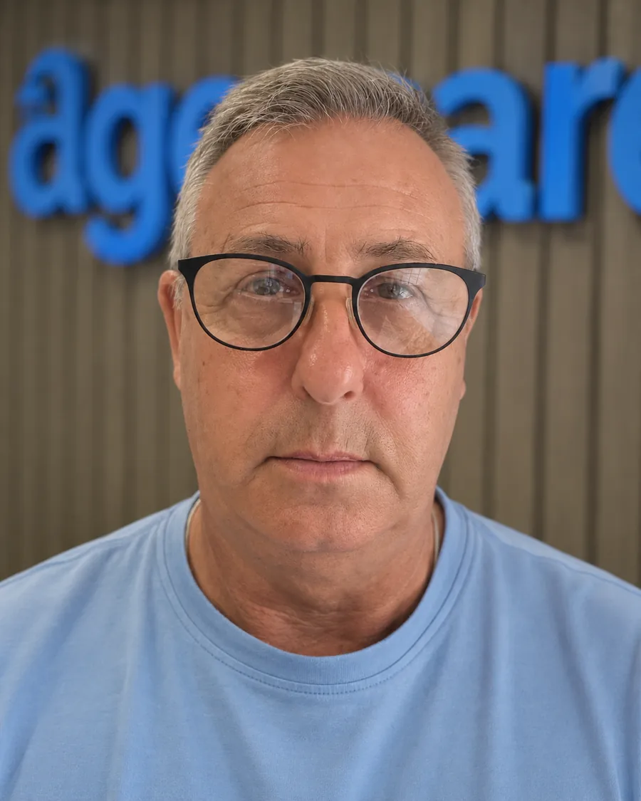 Brian, head of our surveyor team, in front of the Age Care sign at our office.