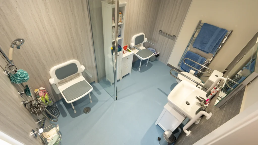 Charlotte's new wet room with fold-down shower seats, non-slip floor, toilet and basin.