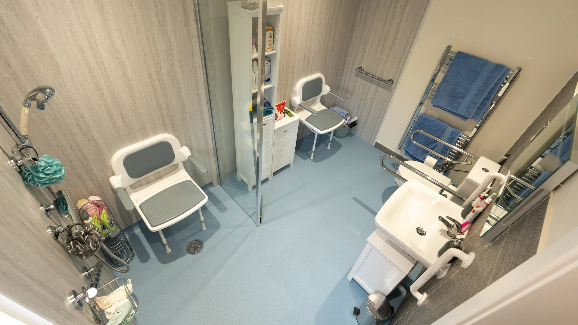 Charlotte's new wet room with fold-down shower seats, non-slip floor, toilet and basin.