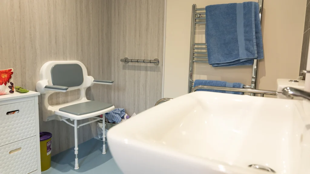 A fold-down shower seat and grab rail in Charlotte's new wet room
