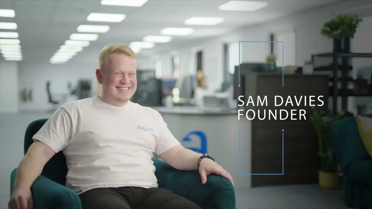 Sam Davies, founder of Age Care Bathrooms, seated in the company office