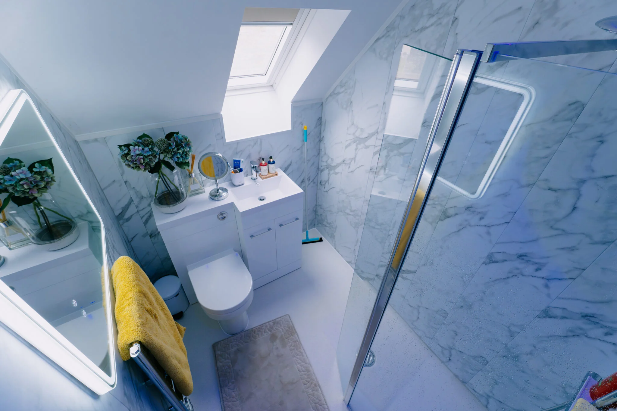Full wet room, completely level access, glass screen and marble effect walls.